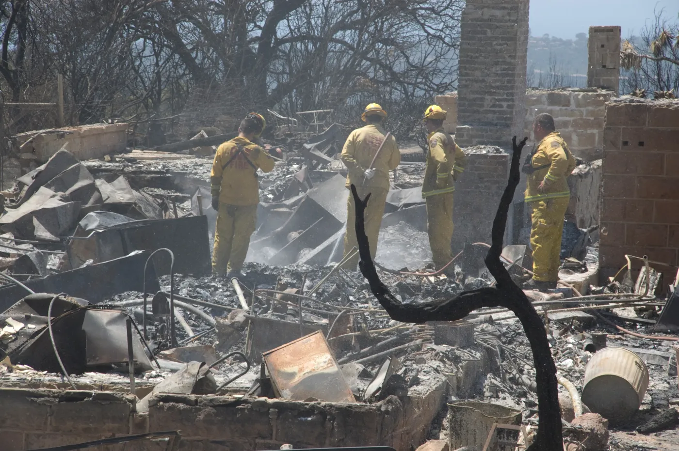 Firefighters put out a hot spot at the Gane House site, after the Jesusita Fire