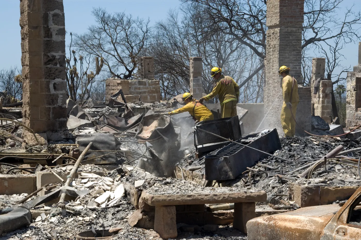 Firefighters put out a hot spot at the Gane House site, after the Jesusita Fire