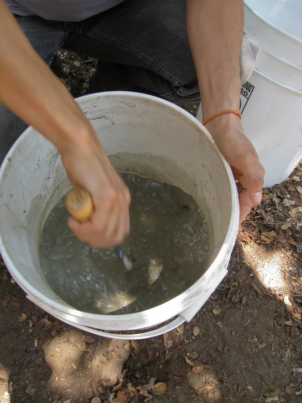 Betsy Lape setting new grid marker in concrete