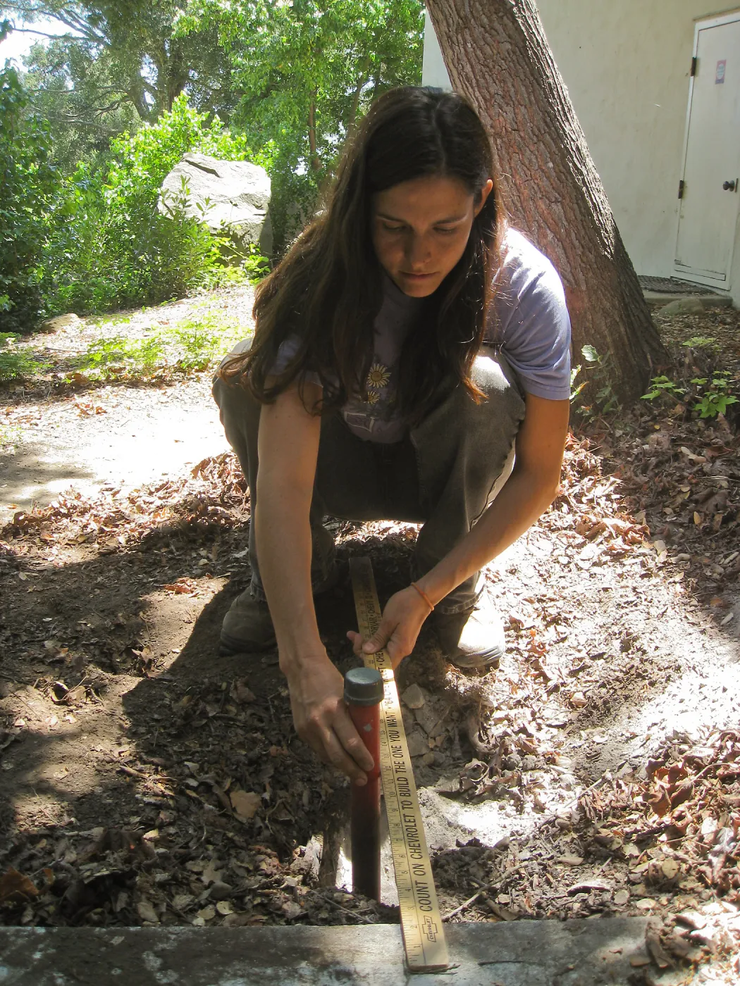 Betsy Lape setting new grid marker in concrete