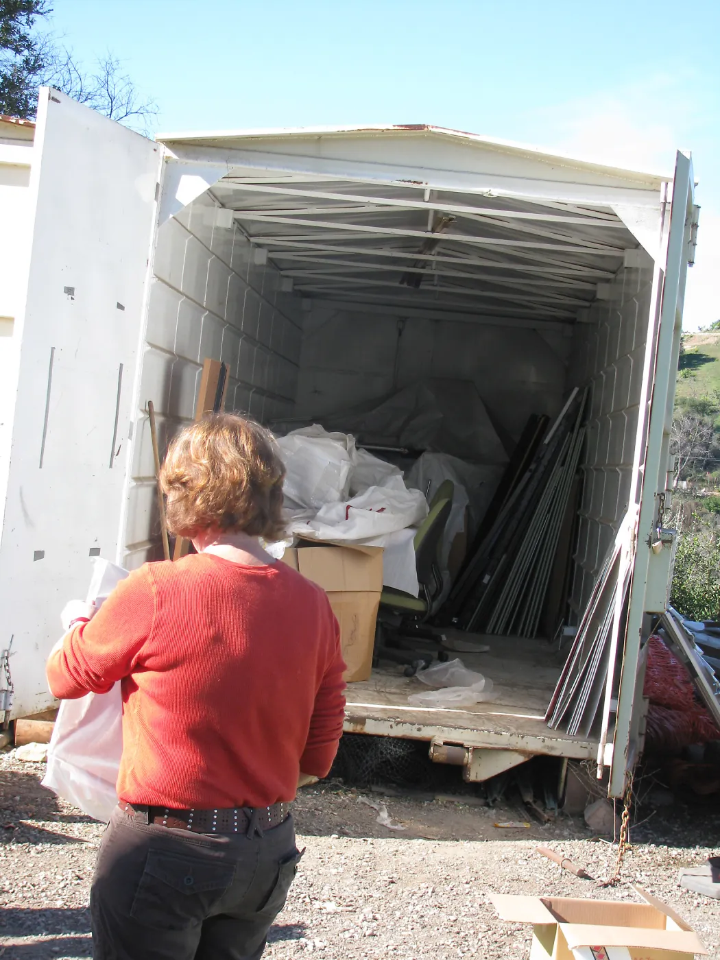 SBBG Staff cleaning out temoporary storage container, after the Jesusita Fire