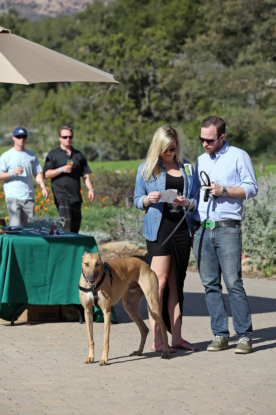 Santa Barbara Beer Garden Event, Sean and Victoria Lewis in foreground, Chris and Jess Parker in the background, dog on leash