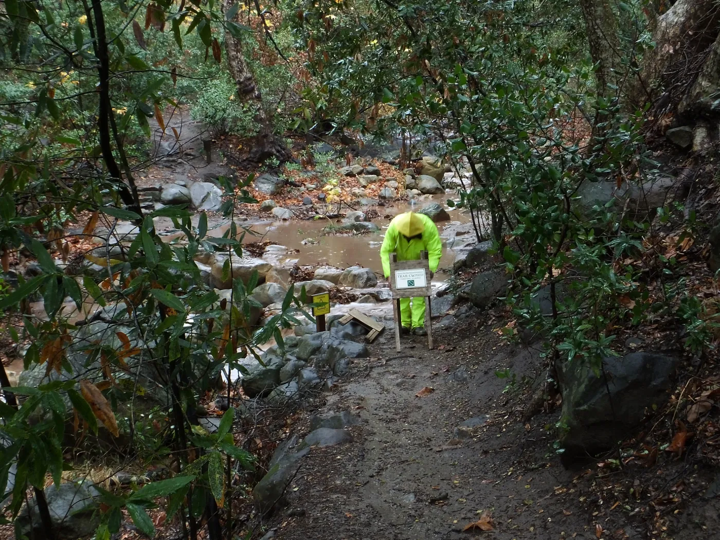 Posting warning signs at lower creek crossing after rain storm