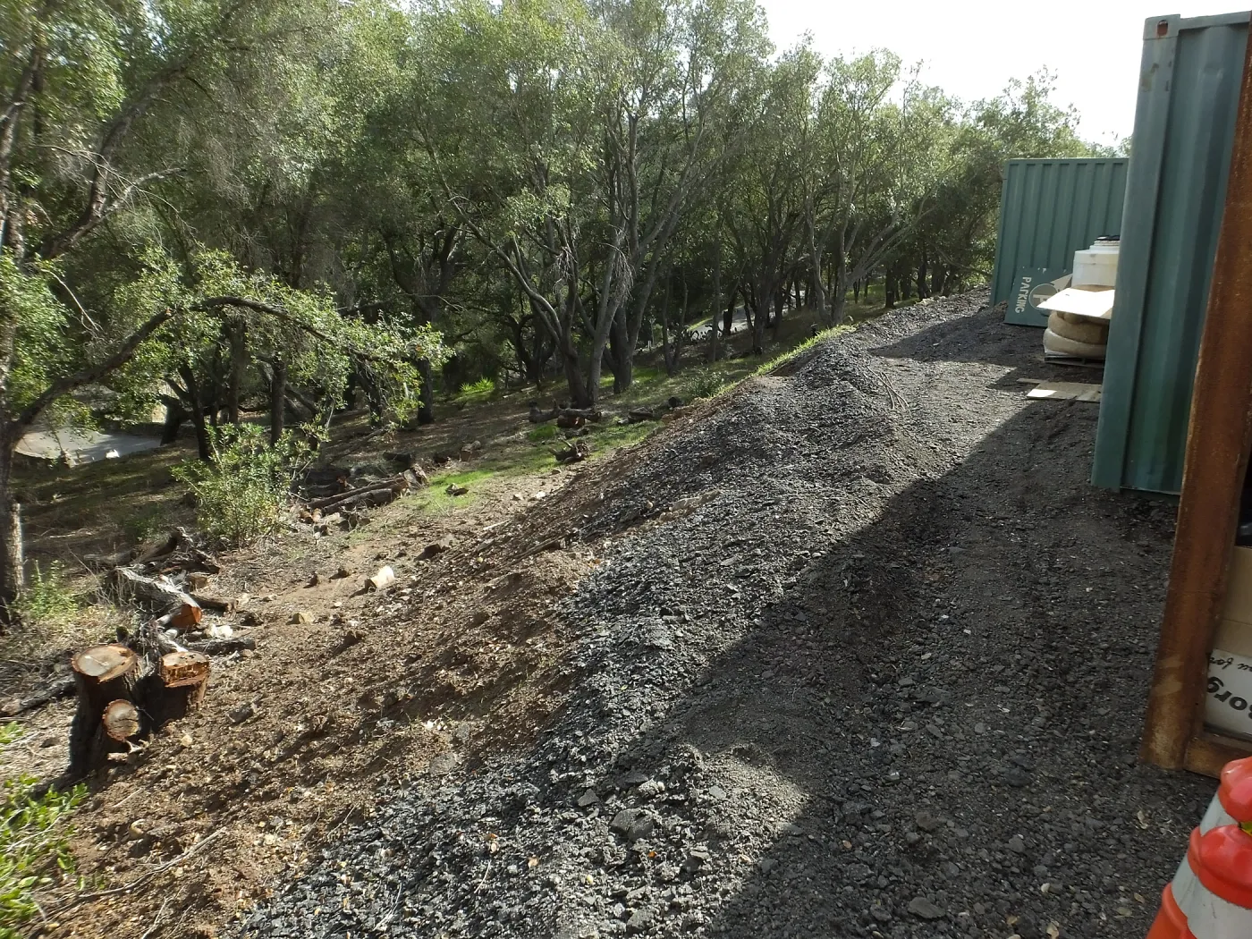Berms behind hort containers to prevent soil erosion into creek and Las Conoas Road