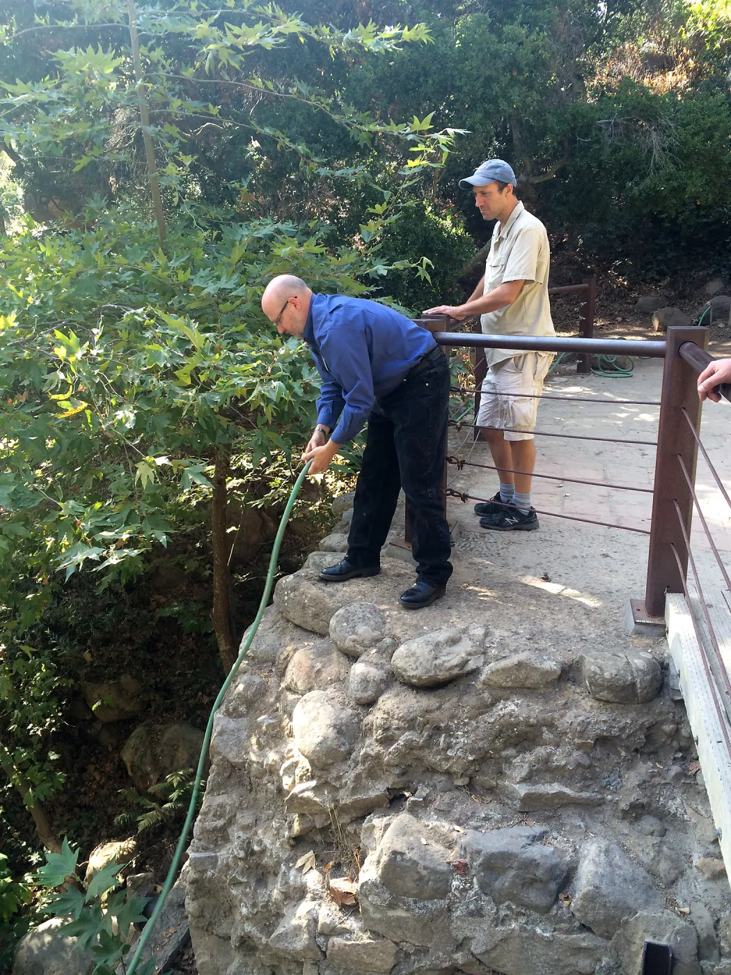 Steve Windhager, putting water into large pond below dam for steelhead survival