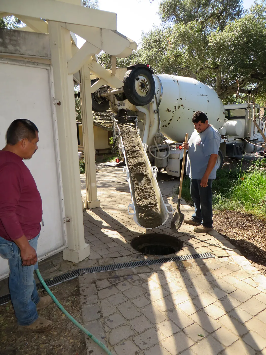 Filling septic tank at entrance with cement slurry