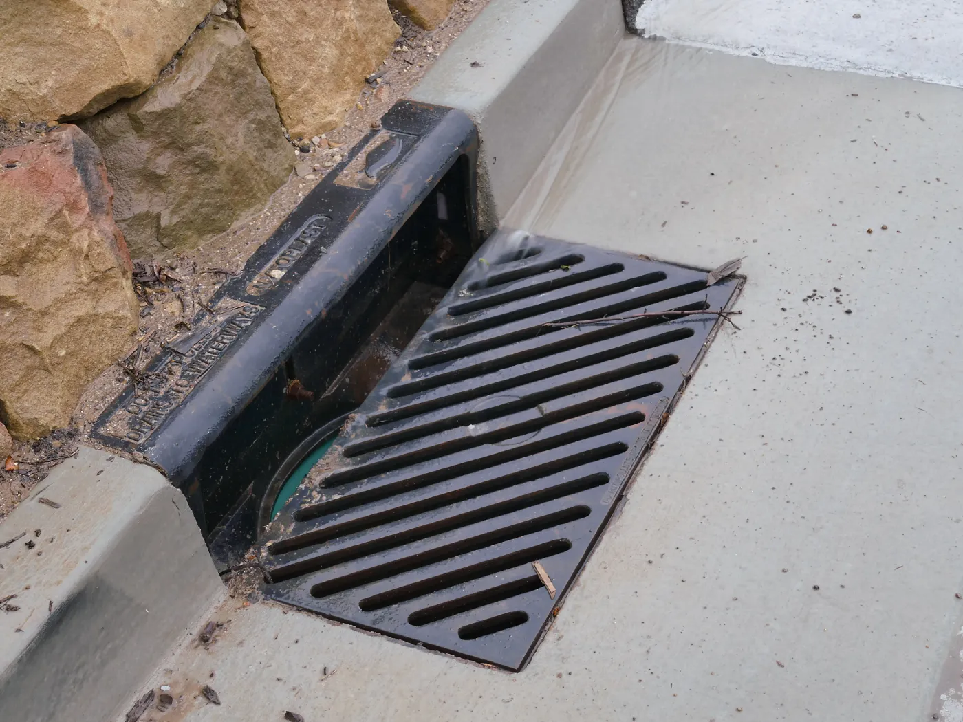 Rainwater entering a storm drain leading to the Pritzlaff Conservation Center bioswale