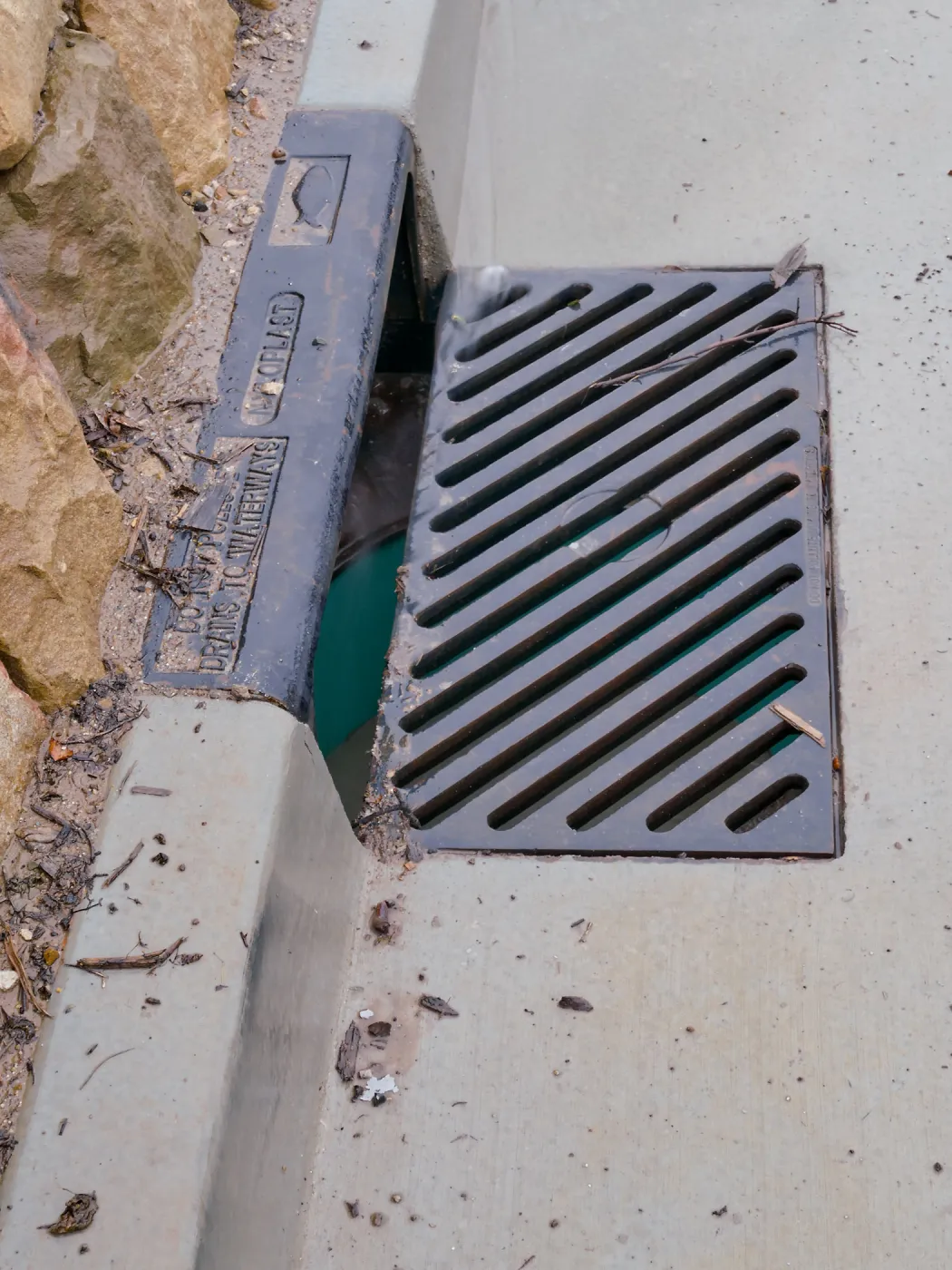 Rainwater entering a storm drain leading to the Pritzlaff Conservation Center bioswale