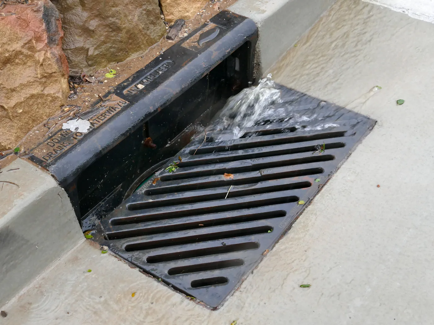 Rainwater entering a storm drain leading to the Pritzlaff Conservation Center bioswale