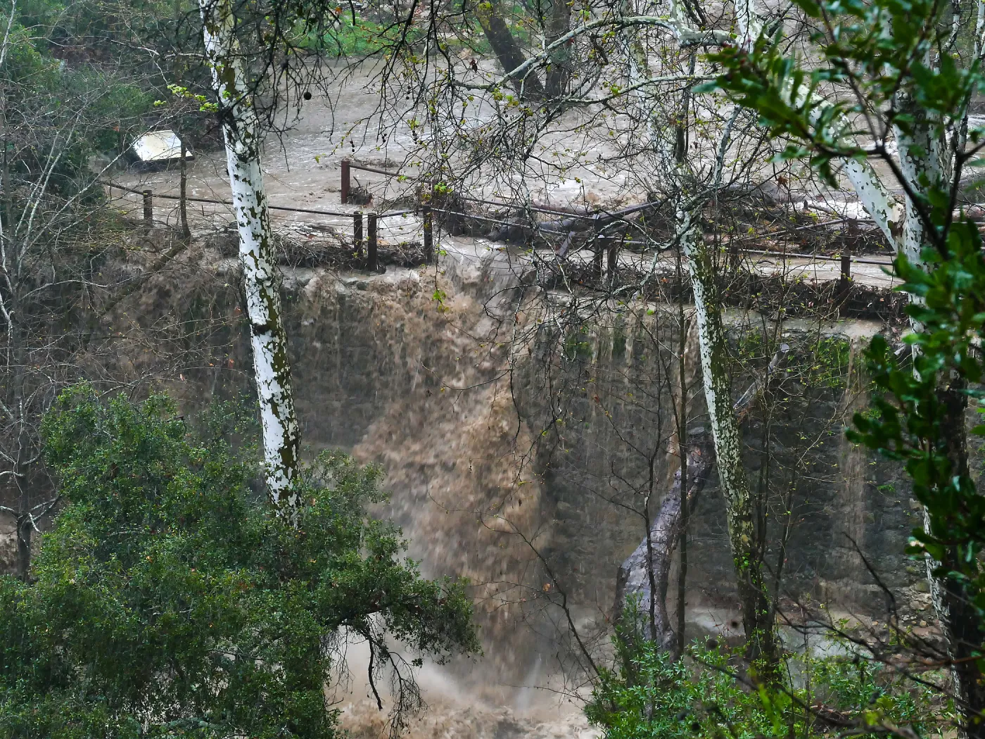 Mission Creek cresting Mission Dam during rainstorm