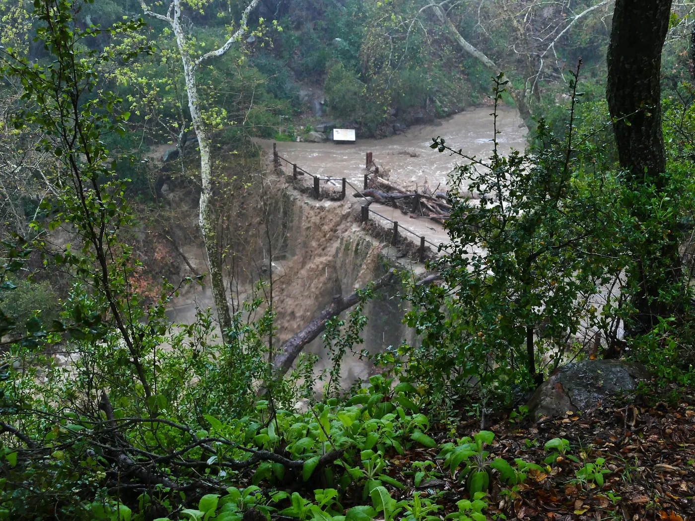 Mission Creek cresting Mission Dam during rainstorm
