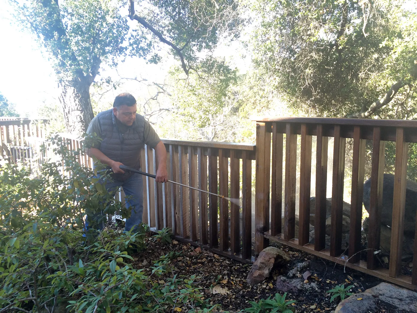 Jim Lechuga pressure washing fence at Water Wise Home Garden