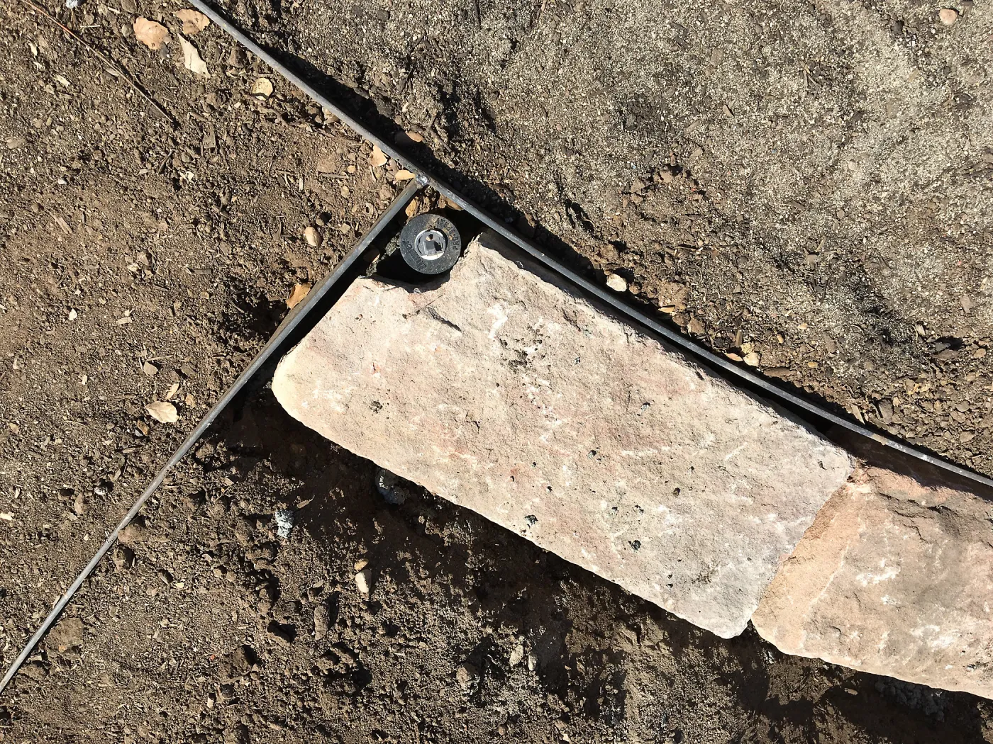Construction of stone edging in Island View Garden lawn