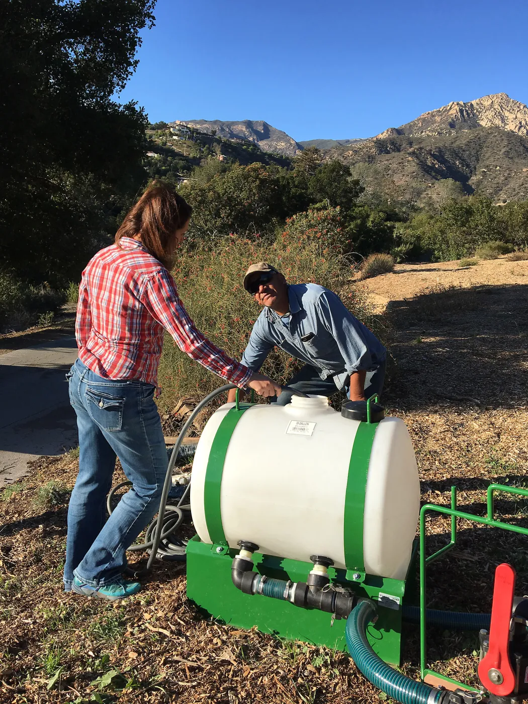 Testing the Hydroseeder.Denise Knapp and Robert Carillo