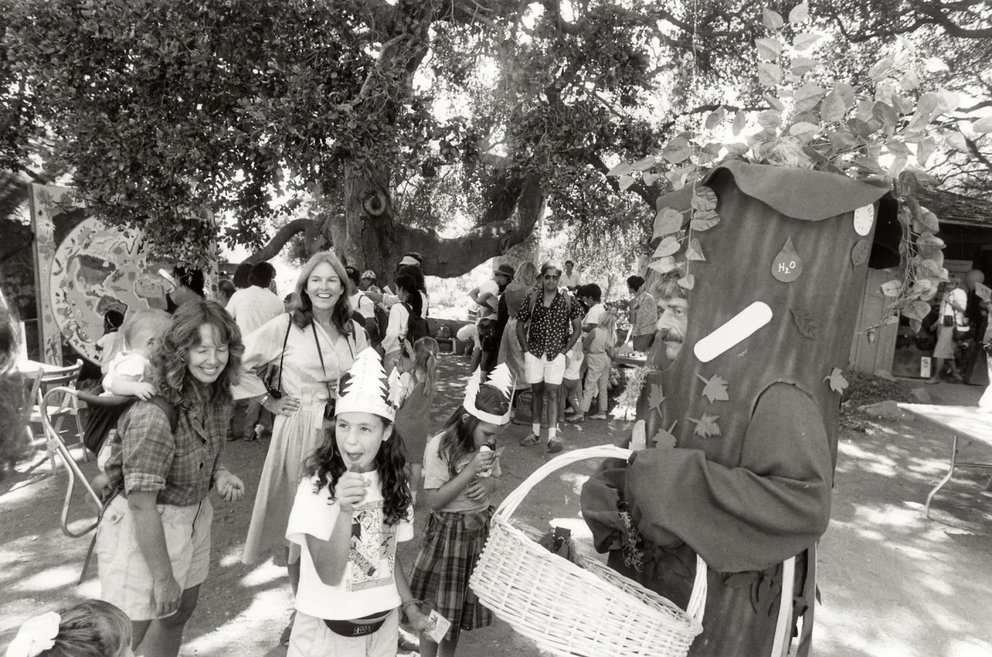 Family Festival, SBBG. A tree with a basket and families having fun
