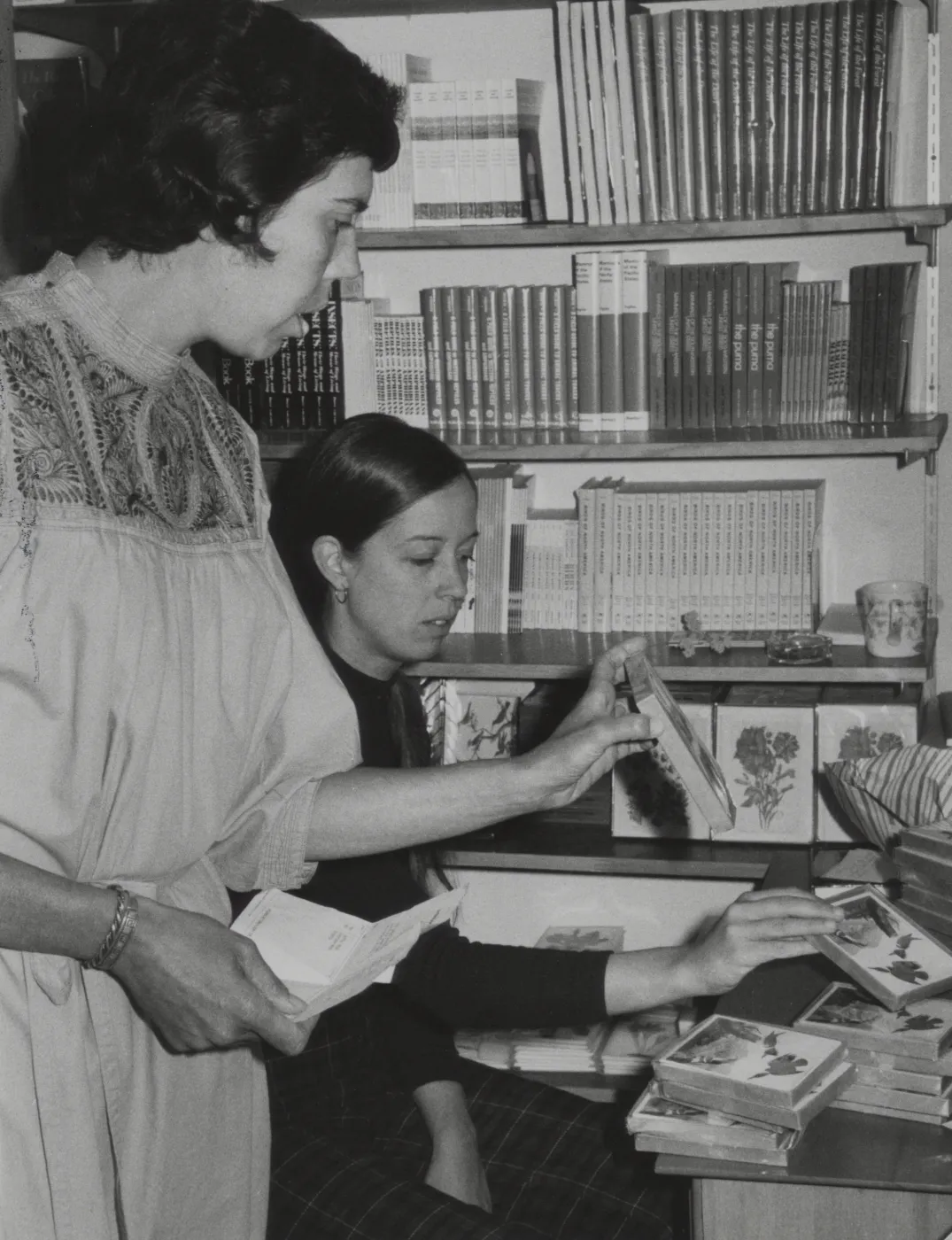 Jacqueline Broughton and Martha Cummings sorting notecards in shop