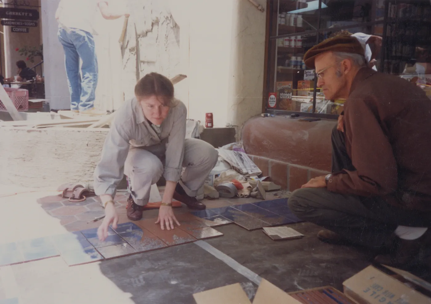 Judy Sutcliff and Dara Emery installing tiles at La Arcada
