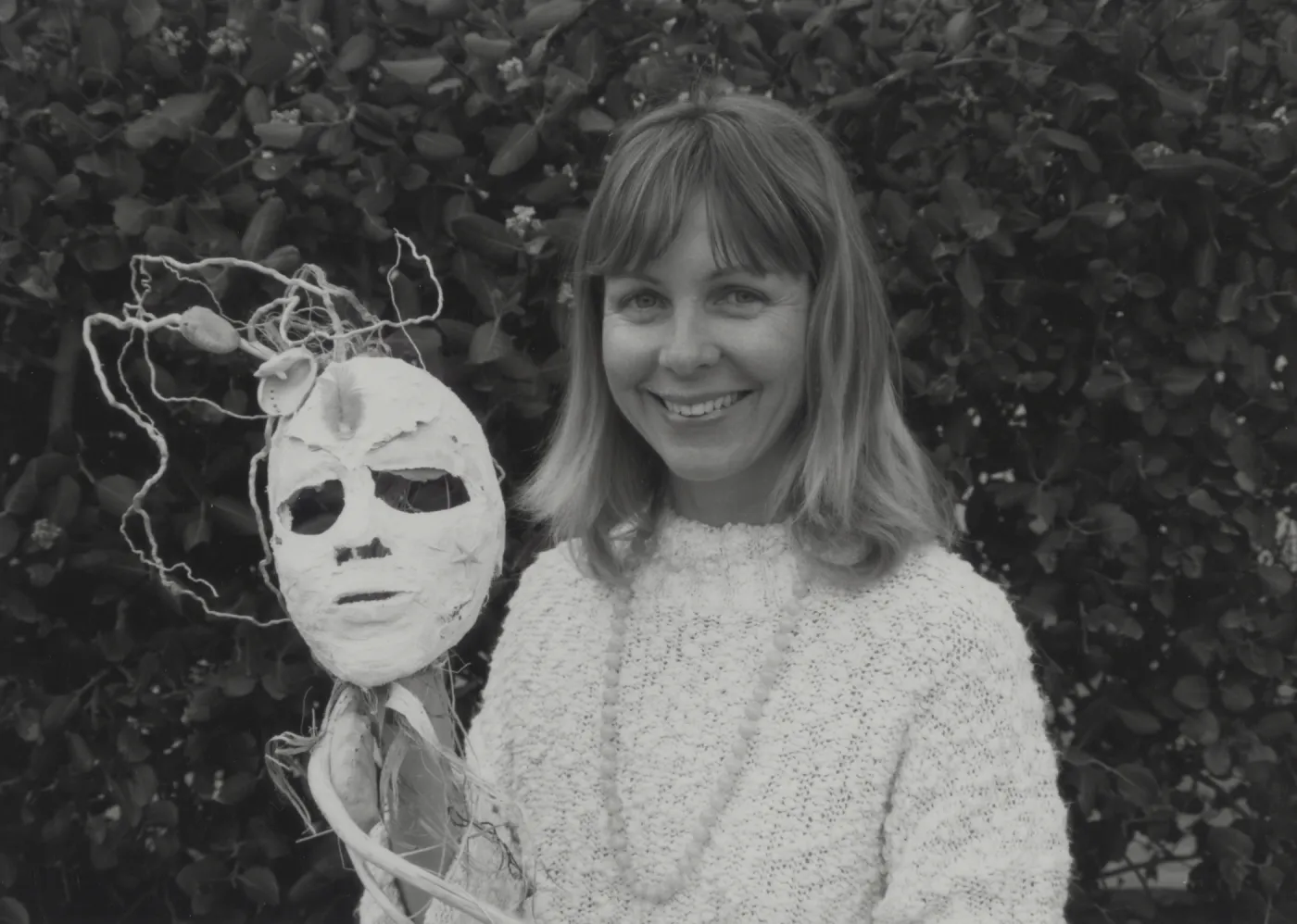 Tara Vance shows off one of the Solstice Parade Masks from her class at the Botanic Garden