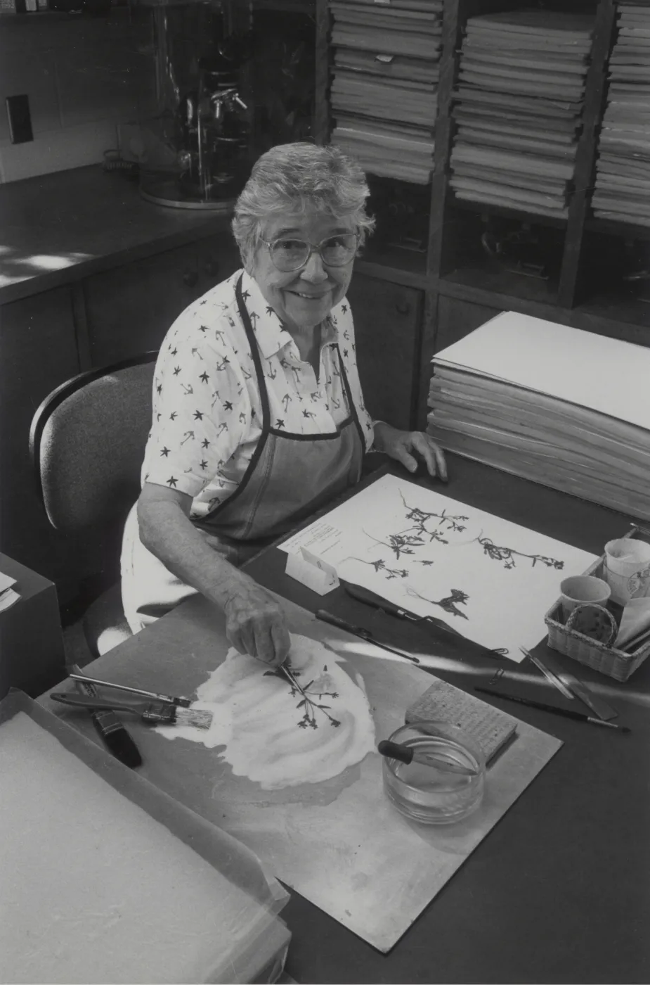 Jean Hobson mounting pressed plant specimens in the Herbarium