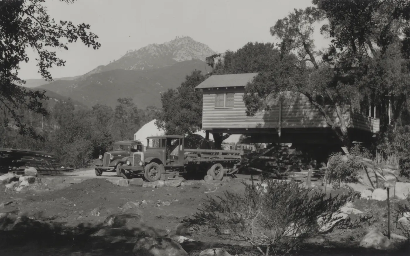 Moving the Cottage building, with greenhouse in background