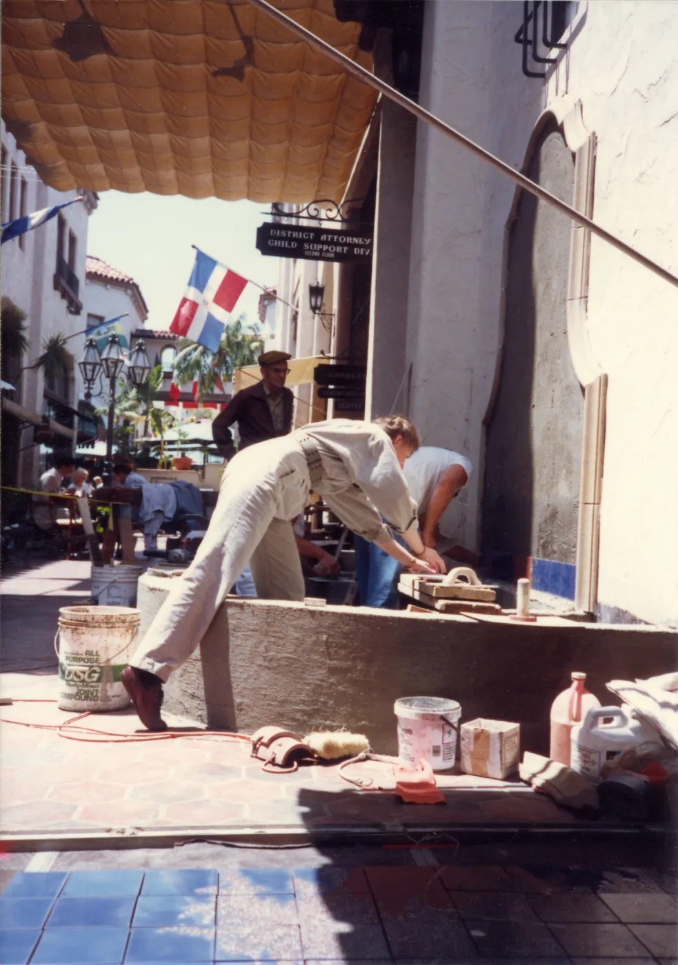 Dara Emery watches Judy Sutcliffe assist installation of new fountain featuring his Lupines