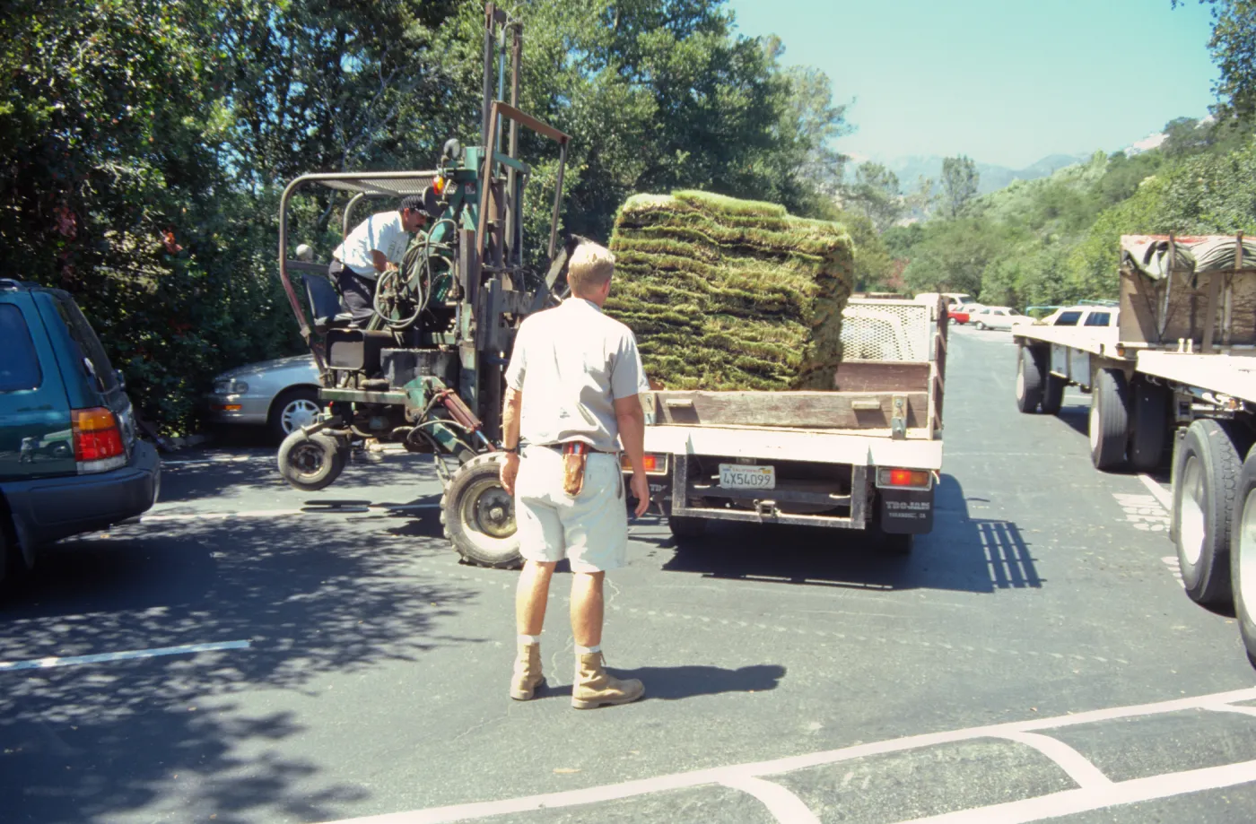 tractor unloading sod for the new Meadow lawn Installation