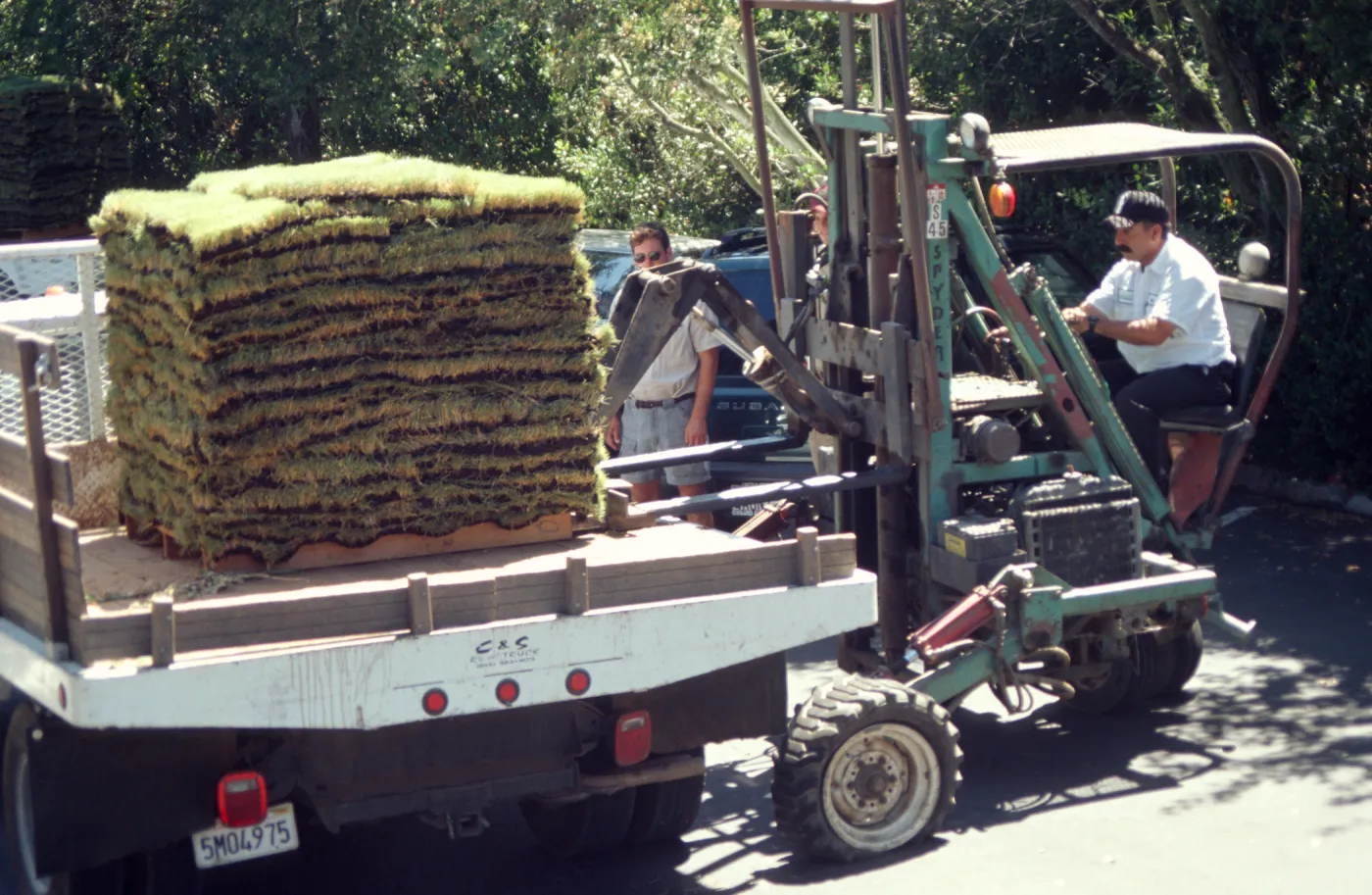 tractor unloading sod for the new Meadow lawn Installation