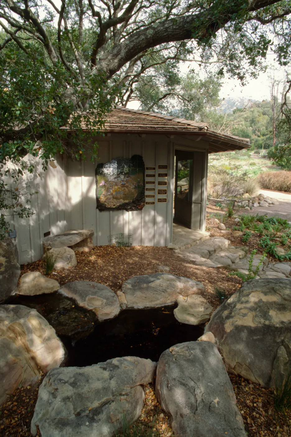Information Kiosk dedication wall, stone bench
