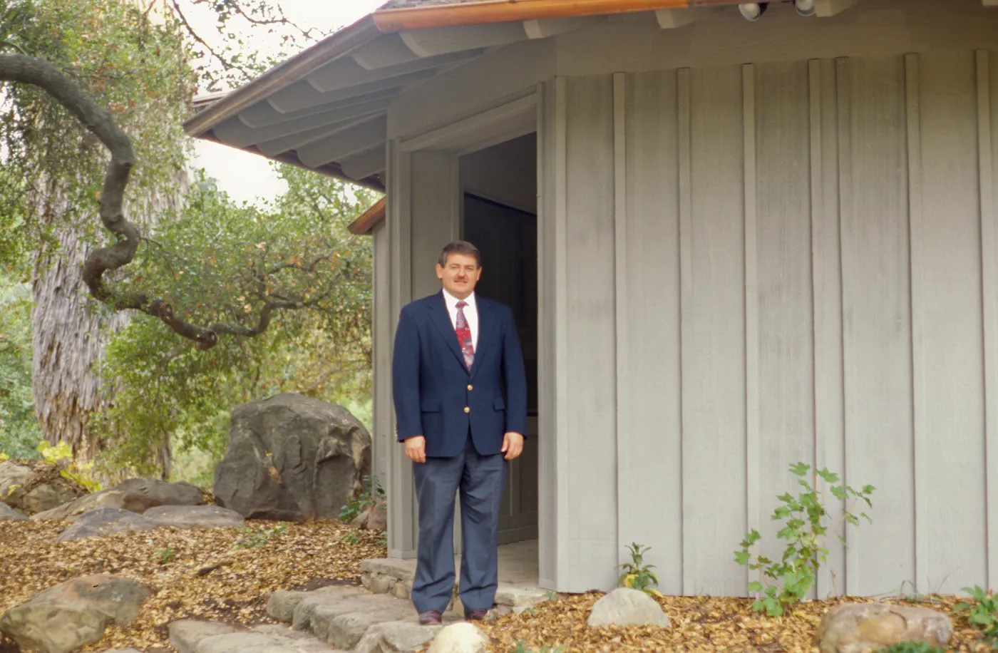 Ed Schneider standing at Information Kiosk after Renovation