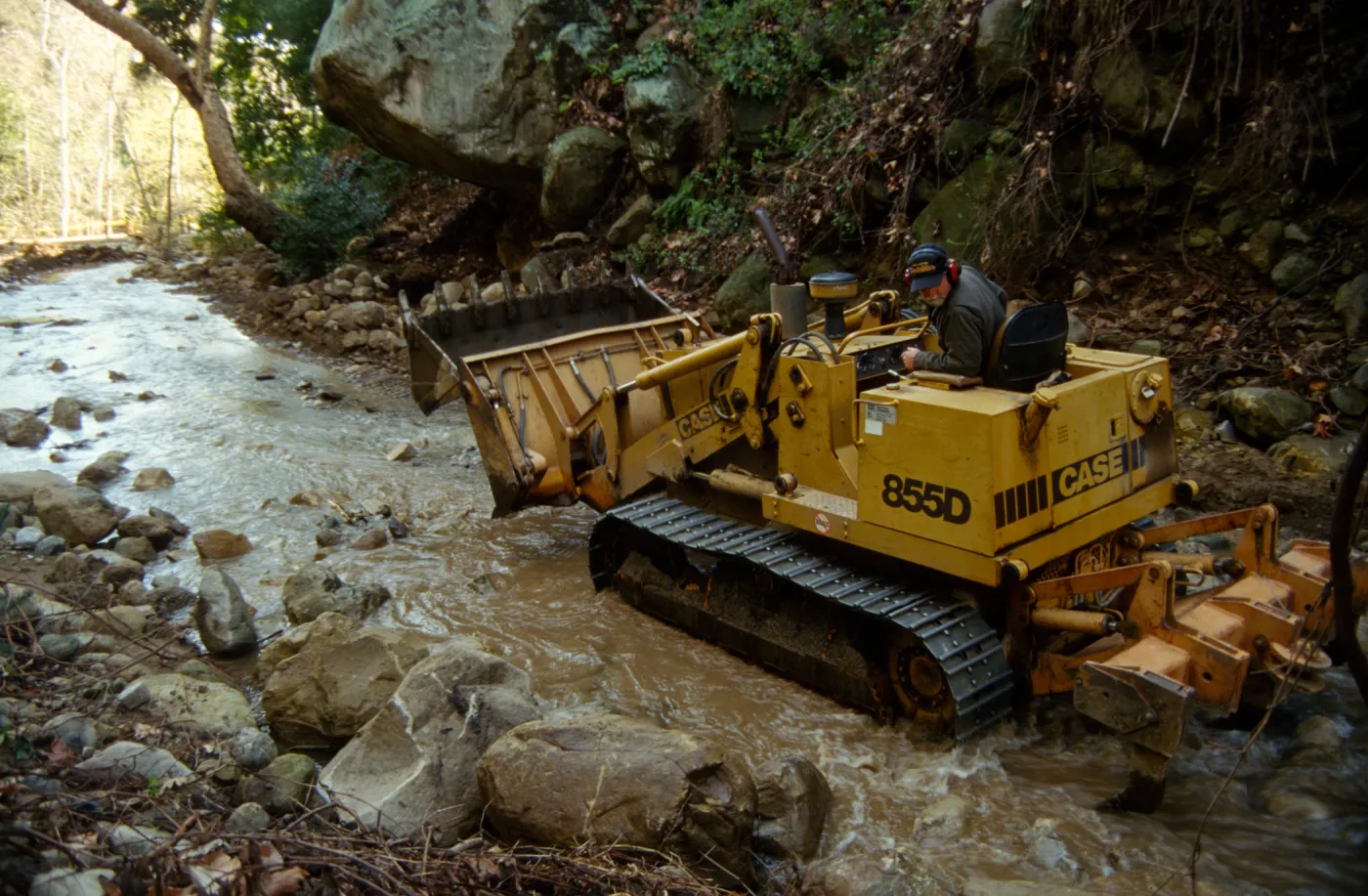 using a tractor to clear Mission Creek above Mission Dam