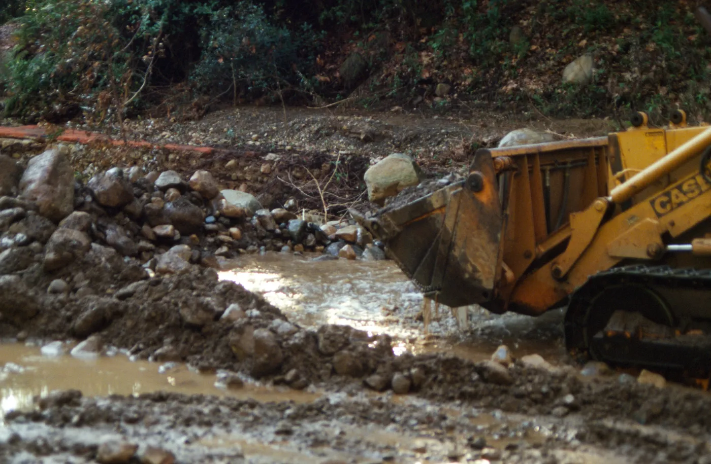 Mission Creek flooded above Mission Dam, with a bulldozer