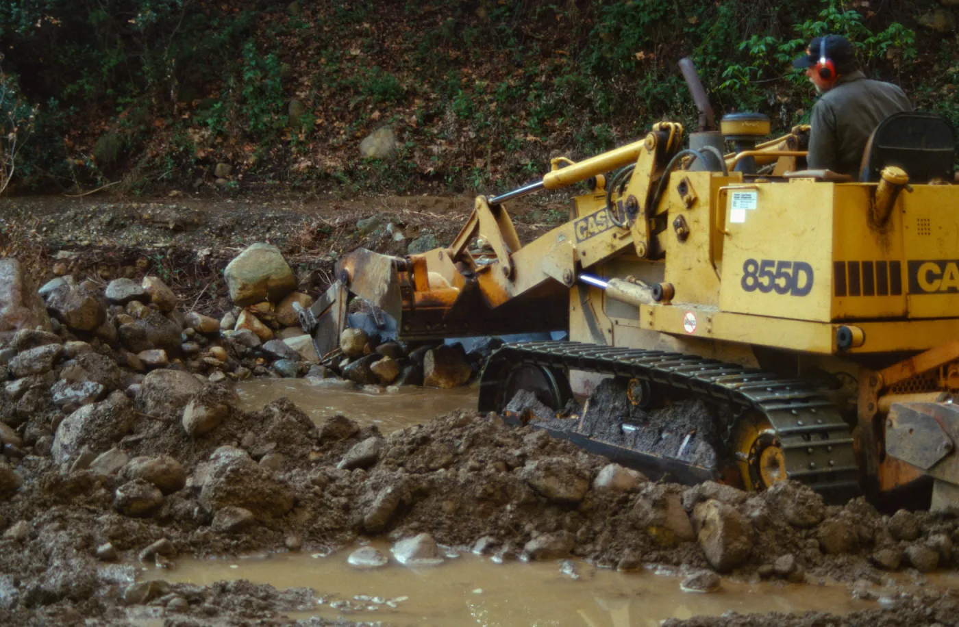 Mission Creek flooded above Mission Dam, with a bulldozer
