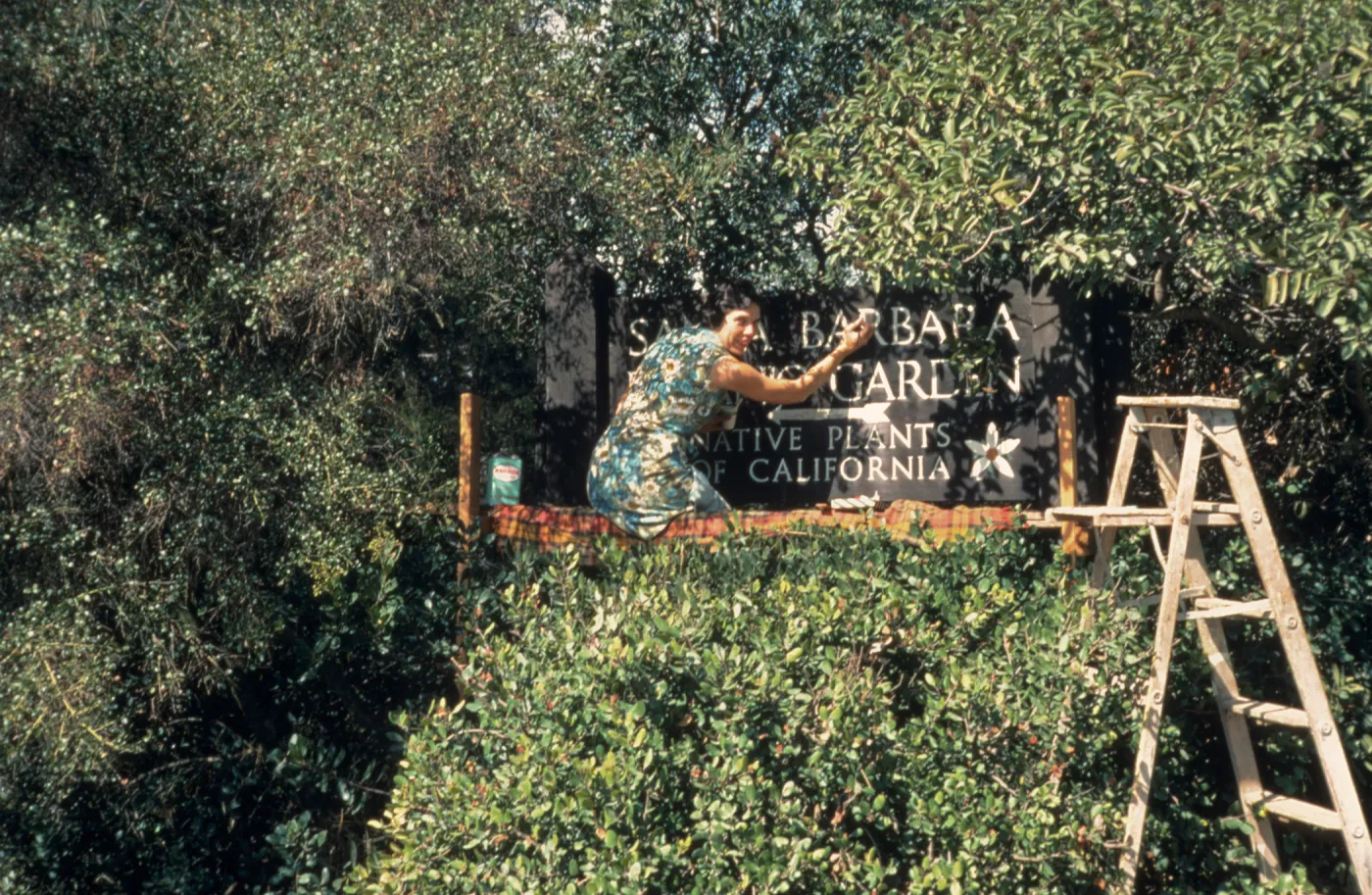Jacqueline Broughton painting the entrance sign