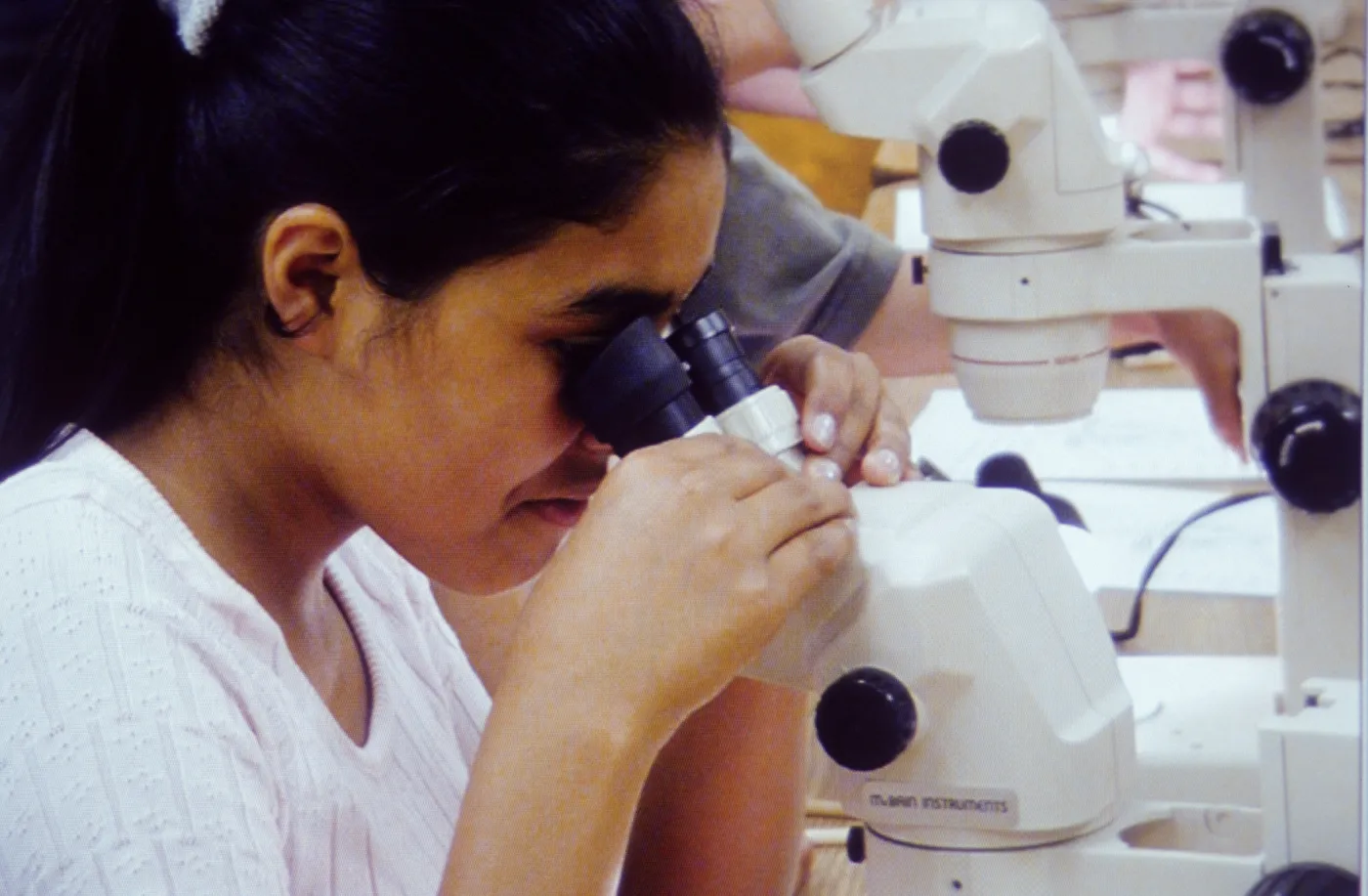 girl using microscope, microscope lab
