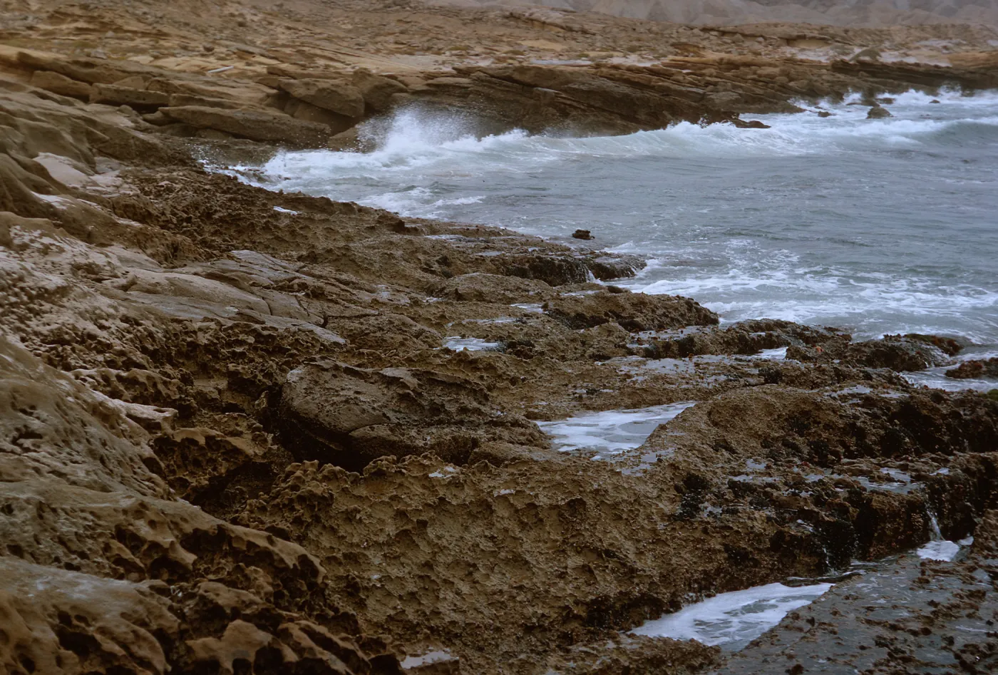 12/ looking East, rocky coast, 1.5 miles Northwest of Dutch Harbor, 65-160 & SN-77