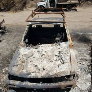 burned trucks in front of Gane House after the Jesusita Fire