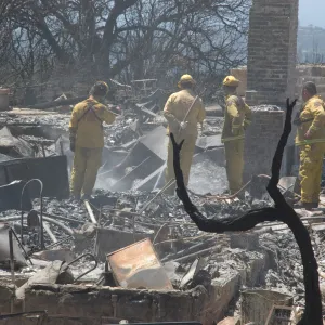 Firefighters put out a hot spot at the Gane House site, after the Jesusita Fire