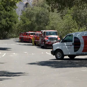 fire trucks and Balfor insurance van in the parking lot, after the Jesusita Fire