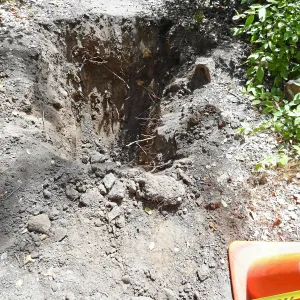 Test pit dug for soil compaction analysis, west side of Campbell Bridge