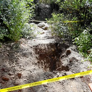Test pit dug for soil compaction analysis, west side of Campbell Bridge