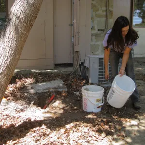 Betsy Lape setting new grid marker in concrete