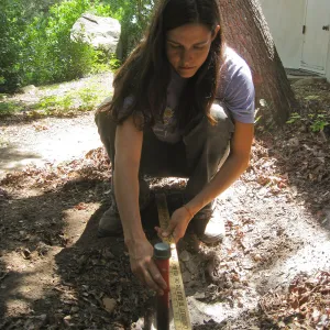 Betsy Lape setting new grid marker in concrete