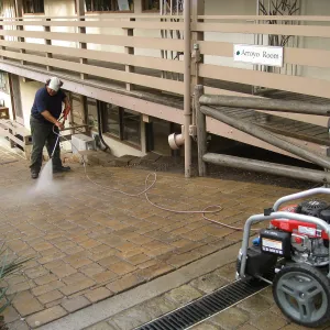 Jim Lechuga powerwashing walkway east side of North Wing