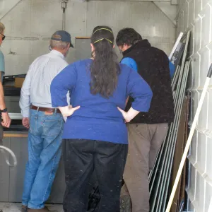 SBBG Staff cleaning out temoporary storage container, after the Jesusita Fire