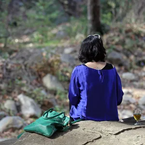 Santa Barbara Beer Garden Event, visitor seated atop a boulder above Mission Creek