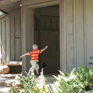 Trails n Tails 2014, boy playing near information kiosk