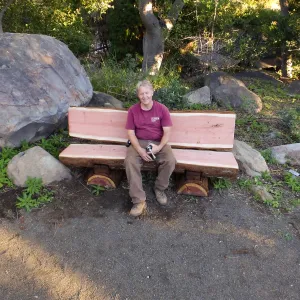 Dave Kershaw testing the newly installed Bobbie Jones bench, which he made from the giant sequoia removed from the Arroyo Section