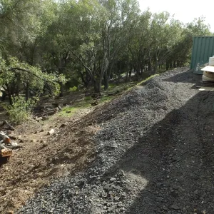 Berms behind hort containers to prevent soil erosion into creek and Las Conoas Road