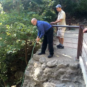 Steve Windhager, putting water into large pond below dam for steelhead survival