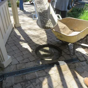 Filling septic tank at entrance with cement slurry